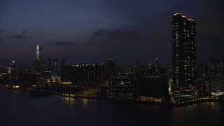 SS01_0158 - 5K stock footage aerial video of Harbourfront Landmark skyscrapers and waterfront apartment buildings at night in Kowloon, Hong Kong, China