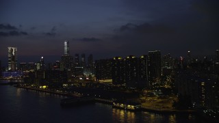 SS01_0159 - 5K stock footage aerial video of waterfront apartment buildings overlooking the harbor at night in Kowloon, Hong Kong, China