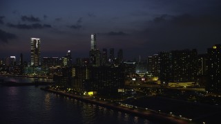 SS01_0160 - 5K stock footage aerial video of waterfront apartment buildings and view of tall towers at night in Kowloon, Hong Kong, China