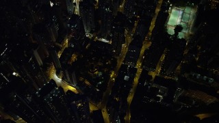 SS01_0169 - 5K stock footage aerial video bird's eye of city streets and office towers at night on Hong Kong Island, China