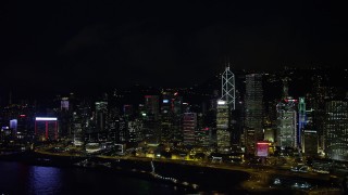 SS01_0187 - 5K stock footage aerial video of tall skyscrapers beside the harbor at night on Hong Kong Island, China