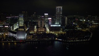 SS01_0189 - 5K stock footage aerial video approach waterfront concert hall, museum and towers at night in Kowloon, Hong Kong, China
