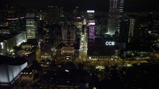 SS01_0190 - 5K stock footage aerial video approach skyscrapers and office buildings on Nathan Road at night in Kowloon, Hong Kong, China