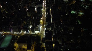 SS01_0194 - 5K stock footage aerial video of flying over Nathan Road past office buildings at Night in Kowloon, Hong Kong, China