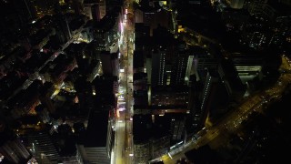 SS01_0195 - 5K stock footage aerial video of following Nathan Road past office buildings at night in Kowloon, Hong Kong, China