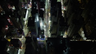 SS01_0198 - 5K stock footage aerial video approach and tilt to bird's eye of city streets and a marketplace at night in Kowloon, Hong Kong, China