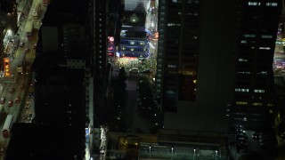 SS01_0209 - 5K stock footage aerial video a slow reverse from corner shop at night in Kowloon, Hong Kong, China
