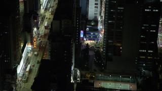 SS01_0210 - 5K stock footage aerial video slow reverse from Kowloon shop at night by busy city street in Hong Kong, China