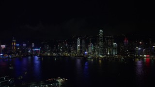 SS01_0216 - 5K stock footage aerial video approach Hong Kong Island skyline from Kowloon at night, China