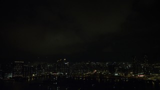 SS01_0231 - 5K stock footage aerial video of lightning flashes above Kowloon waterfront apartment buildings at night, China