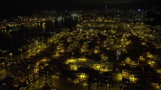 SS01_0234 - 5K stock footage aerial video fly over stacks of containers at the Port of Hong Kong at night, China