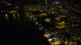 SS01_0238 - 5K stock footage aerial video flyby a pair of cargo ships docked at the Port of Hong Kong at night, China