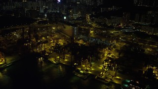 SS01_0239 - 5K stock footage aerial video of cargo cranes at the Port of Hong Kong at night, China
