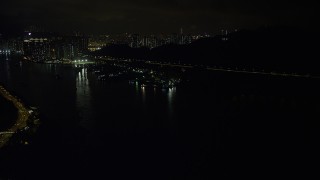 SS01_0250 - 5K stock footage aerial video approach small piers and warehouses on Rambler Channel at night in Hong Kong, China