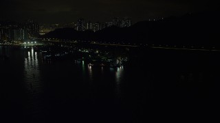 SS01_0251 - 5K stock footage aerial video approach poorly lit piers and warehouses on Rambler Channel at night in Hong Kong, China