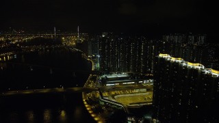 SS01_0257 - 5K stock footage aerial video of tall apartment complexes by the channel at night on Tsing Yi Island, Hong Kong, China