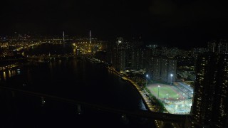 SS01_0258 - 5K stock footage aerial video approach Stonecutters Bridge from waterfront apartment complexes on Tsing Yi Island at night, China