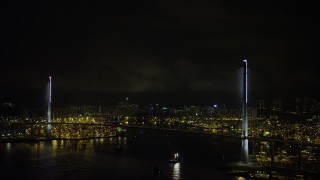 SS01_0269 - 5K stock footage aerial video of Stonecutters Bridge at Night in Hong Kong with lightning flashes overhead, China