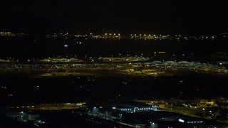 SS01_0278 - 5K stock footage aerial video of airliners and terminals at the Hong Kong International Airport at night, China