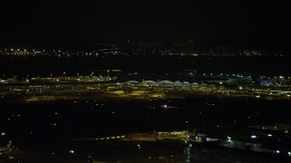 SS01_0279 - 5K stock footage aerial video of airliners parked at the terminal at Hong Kong International Airport at night, China