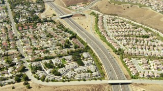 TS01_003 - 1080 stock footage aerial video of a bird's eye view of 118 freeway and homes in Simi Valley, California