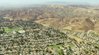 TS01_006 - 1080 stock footage aerial video fly over homes toward hills in Simi Valley, California
