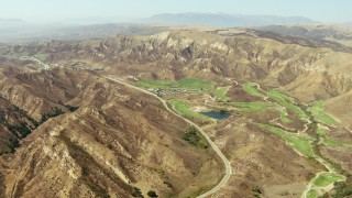 TS01_008 - 1080 stock footage aerial video approach golf course and brown hills in Simi Valley, California