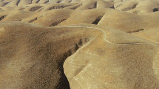 TS01_099 - 1080 stock footage aerial video of a dirt road atop a hill in San Ardo, California