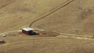 TS01_114 - 1080 aerial stock footage video of of a lone red barn in Paicines, California
