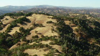 TS01_120 - 1080 stock footage aerial video of flying over hills to reveal a lake near Morgan Hill, California