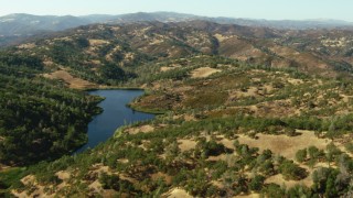 TS01_122 - 1080 stock footage aerial video of flying over a lake and hills in Morgan Hill, California