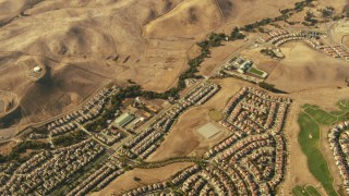TS01_136 - 1080 stock footage aerial video tilt from homes and hills in Dublin to reveal homes in San Ramon, California