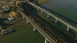 TS01_152 - 1080 stock footage aerial video follow Benicia-Martinez Bridge, tilt to reveal refinery in Benicia, California
