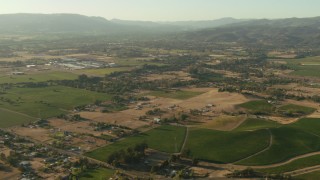 TS01_171 - 1080 stock footage aerial video pan across farms, hills and homes to reveal small airfield in Sonoma, California