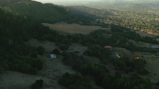 TS01_196 - 1080 stock footage aerial video of flying over hills and barn to homes in Bennett Valley, California