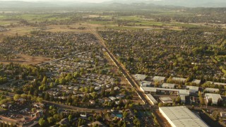 TS01_201 - 1080 stock footage aerial video tilt from train tracks between homes and warehouses, reveal farms, Santa Rosa, California