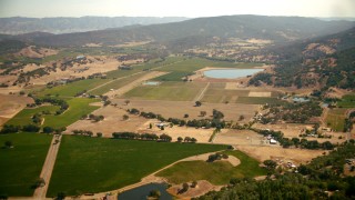 TS01_247 - 1080 stock footage aerial video pan across vineyards to the Pope Valley Airport, California