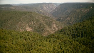 TS01_283 - 1080 stock footage aerial video fly over trees to approach tall mountains in the Sierra Nevada Mountains, California