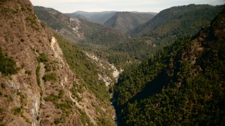 TS01_287 - 1080 stock footage aerial video of flying between mountain slopes in the Sierra Nevada Mountains, California