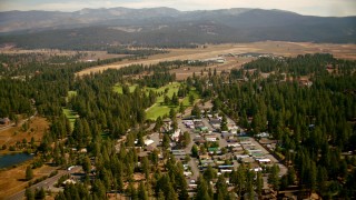 TS01_305 - 1080 stock footage aerial video of flying over mobile homes and golf course toward the airfield in Truckee, California