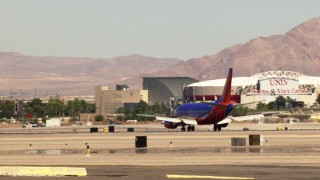 TS02_47 - 1080 stock footage aerial video of tracking a Southwest passenger jet at McCarran International Airport, Las Vegas, Nevada