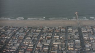 WA001_002 - 4K stock footage aerial video fly over homes, Manhattan Beach Pier, and the Pacific Ocean, California