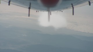 WA001_025 - 4K stock footage aerial video of reverse view of the underside of the jet and contrail over Los Padres National Forest, California