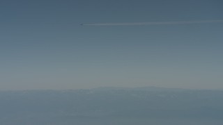 WA001_030 - 4K stock footage aerial video air-to-air of a jet airplane contrail over mountains in the distance, Solano County, California