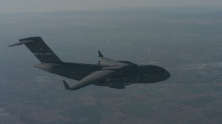 WA001_036 - 4K stock footage aerial video fly beside a Boeing C-17 over Solano County, zoom to a wider view, California