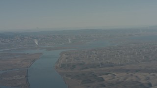 WA001_048 - 4K stock footage aerial video air-to-air view of a jet flying over Sacramento River and windmills, Solano County, California