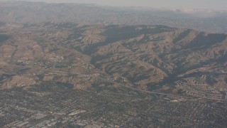 WA002_004 - 4K stock footage aerial video fly over suburban homes to approach Highway 118 and the mountains, Chatsworth, California
