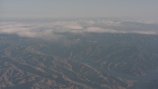 WA002_008 - 4K stock footage aerial video approach clouds near Castaic Lake in the Sierra Pelona Mountains, California