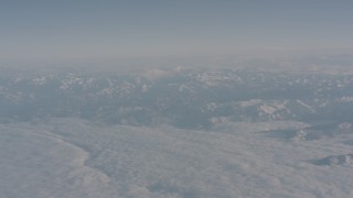 WA002_032 - 4K stock footage aerial video of clouds around snowy Sierra Nevada Mountains, California