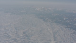 WA002_039 - 4K stock footage aerial video tilt from the Sierra Nevada Mountains to a bird's eye view of clouds, California